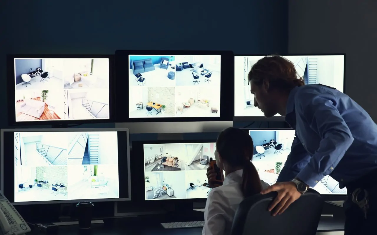 Security officer monitoring CCTV screens in a Houston facility