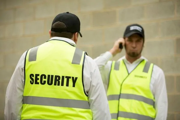 Construction site guards monitoring safety operations