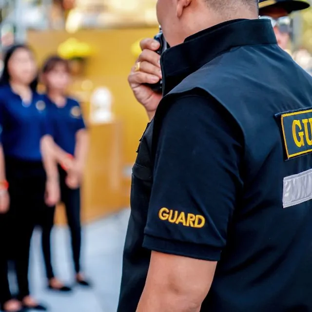 Head security guard assessing the area during an emergency.