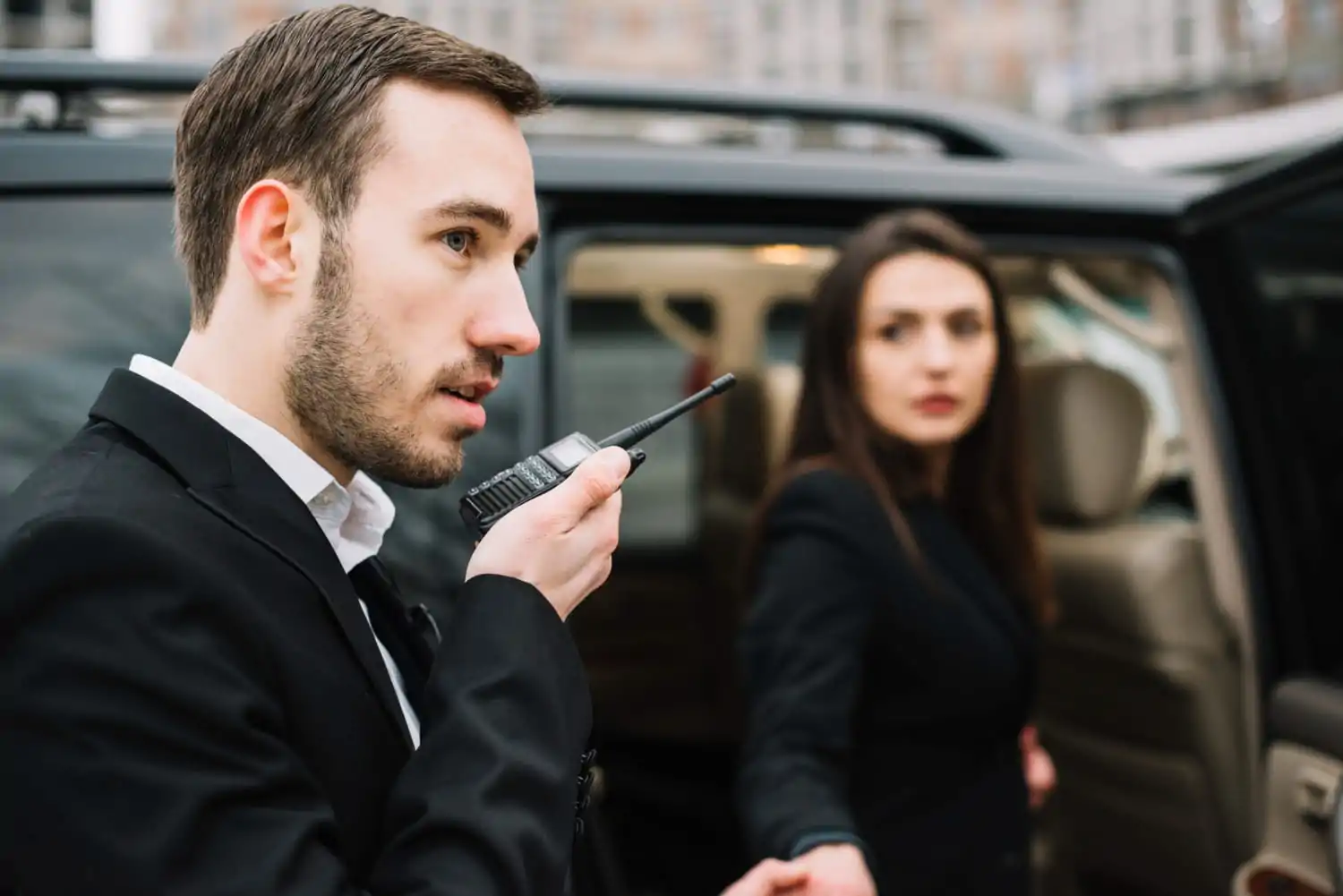 A VIP guard using a walkie-talkie