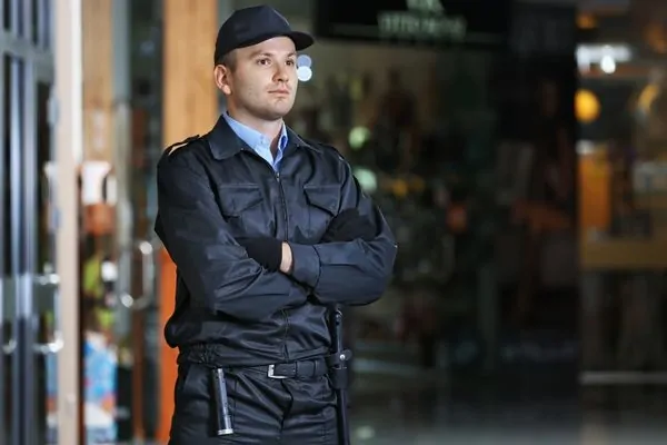 Security guard monitoring shoppers inside mall