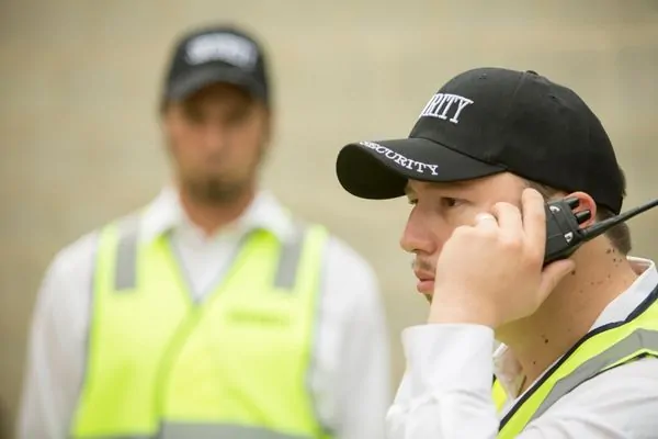 Security guard on duty holding communication radio