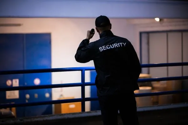 Security guard conducting night property patrol