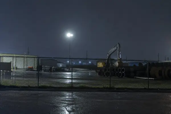Unsecured Houston construction site with equipment and materials at night