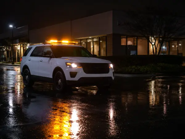 Security patrol vehicle outside a Houston commercial building at night