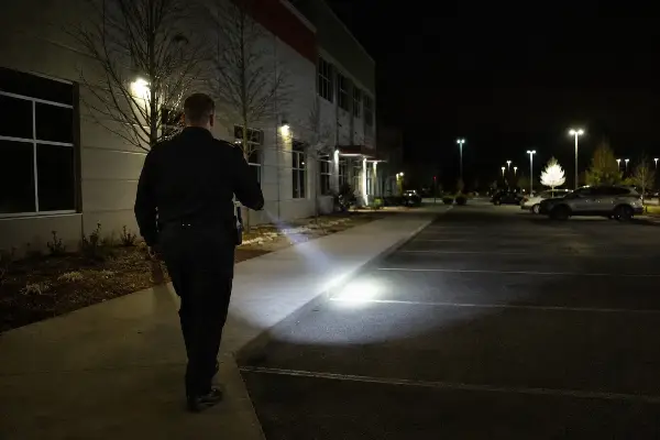 Security officer on night foot patrol at a Houston commercial building